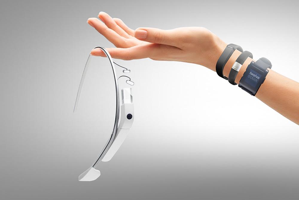 A hand holding google glass, with an arm wearing several tracking devices