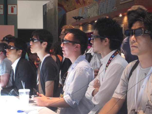 Gamers and onlookers experiencing Motorstorm: Apocalypse in 3D.