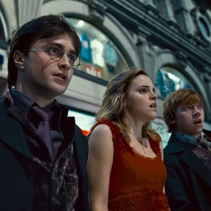 Harry, Ron, and Hermione looking scared in the middle of a crowded street in HP and the Deathly Hallows Part 1