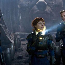 Three astronauts stand in an abandoned area in Prometheus.