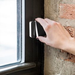 Scout window sensor being installed on window.