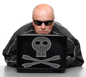 Hacker behind laptop