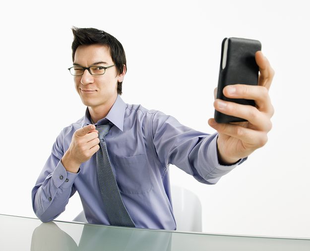 bigstock_Businessman_taking_photograph__12847850