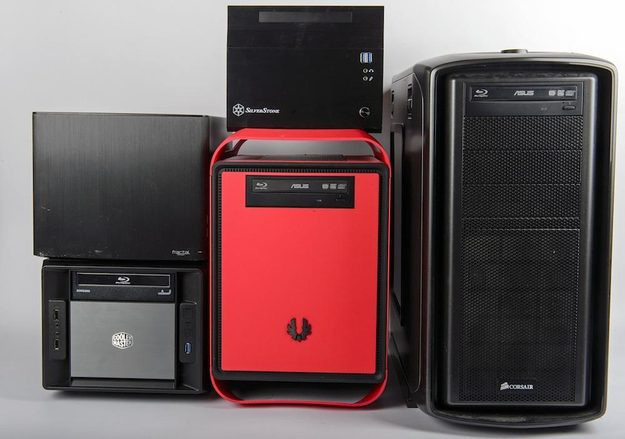 Four mini-ITX cases, next to a more traditional mid-tower PC case on the right.