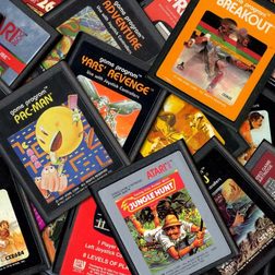 Atari cartridges sit in a pile.