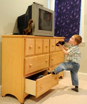Falling television chest tipover