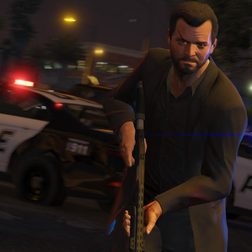 Character holding a gun in front of a police car in Grand Theft Auto 5.