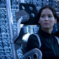 A woman sits down in a scene from Catching Fire.