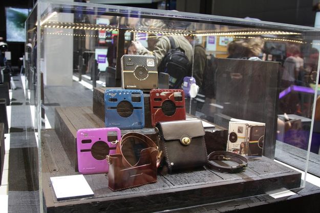 The Socialmatic camera was placed behind glass at at Polaroid's booth, nor was there a working unit. You can see the different faceplates you can snap onto the camera.