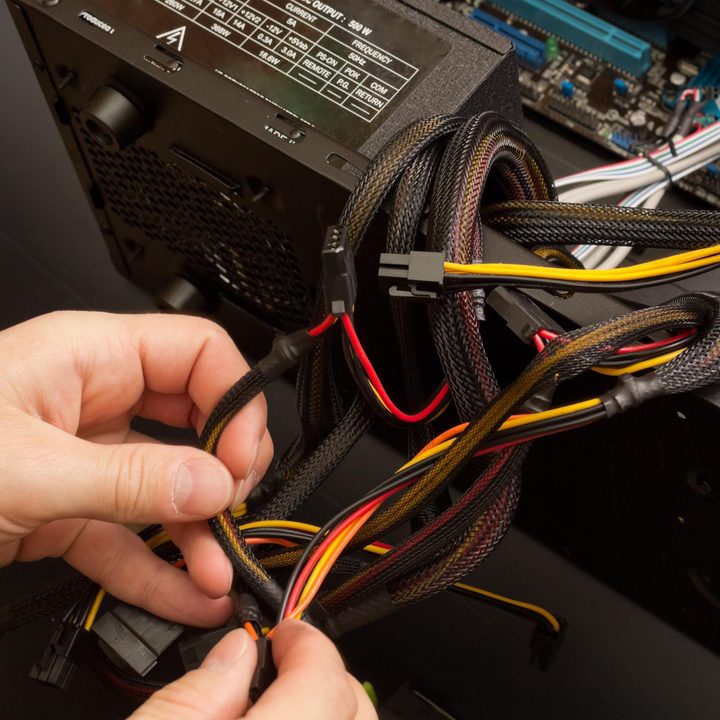 Somone untangling PSU cables.