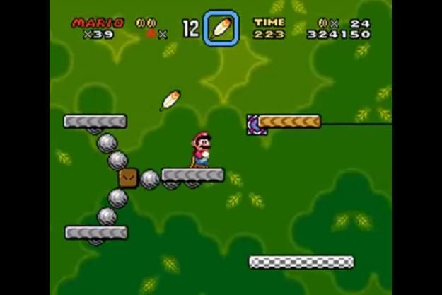 Mario platforming in Super Mario World.