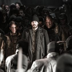 Jamie Bell, Chris Evans, and other cast members standing in Snowpiercer (2013).