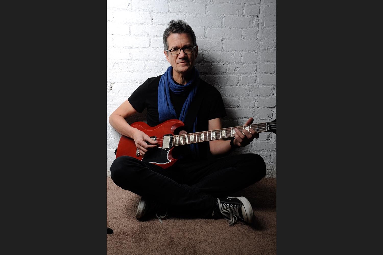 JON-HERINGTON-2---SITTING-WRED-GUITAR-VERTICAL