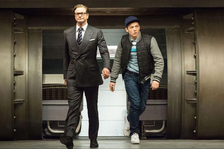 Two men walk side by side in a vault in "Kingsman: The Secret Service."