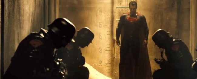 Soldiers sporting the sign for the house of El kneel before Superman.