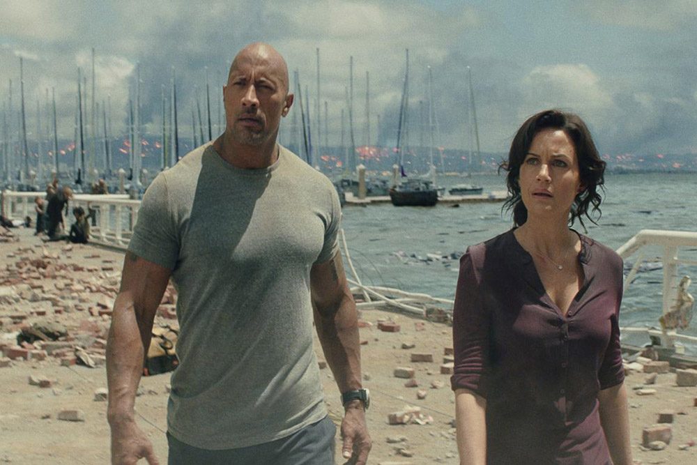 The Rock walks with a woman.