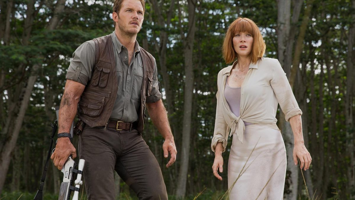 A man and woman stand next to each other in Jurassic World.