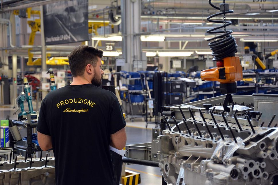Employees wear a black Lamborghini uniform that clearly indicates whether they’re assembly line workers, part of the factory’s logistics team, assigned to the prototype-building division and so forth. “Produzione” (Italian for “production”) means the man pictured here is an assembly line worker.