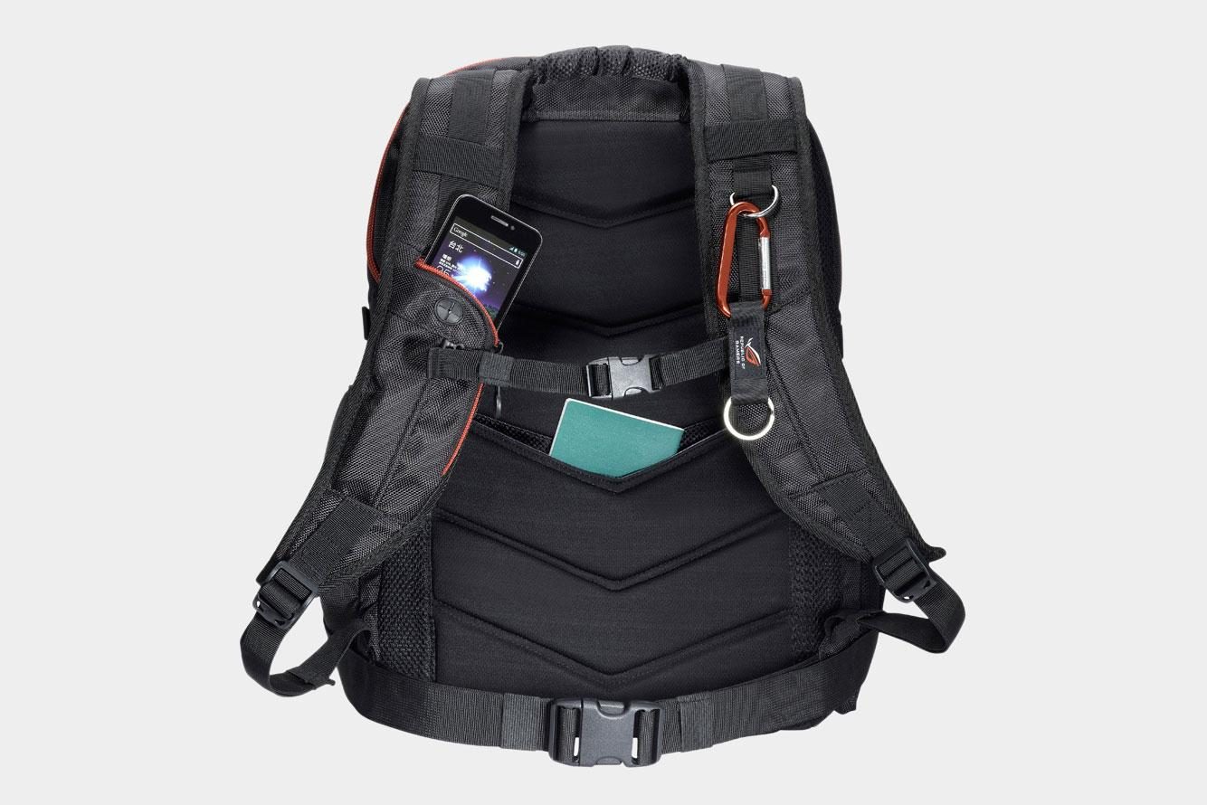 The back side of the Asus ROG Nomad V2 backpack as it holds a person's stuff including a phone.