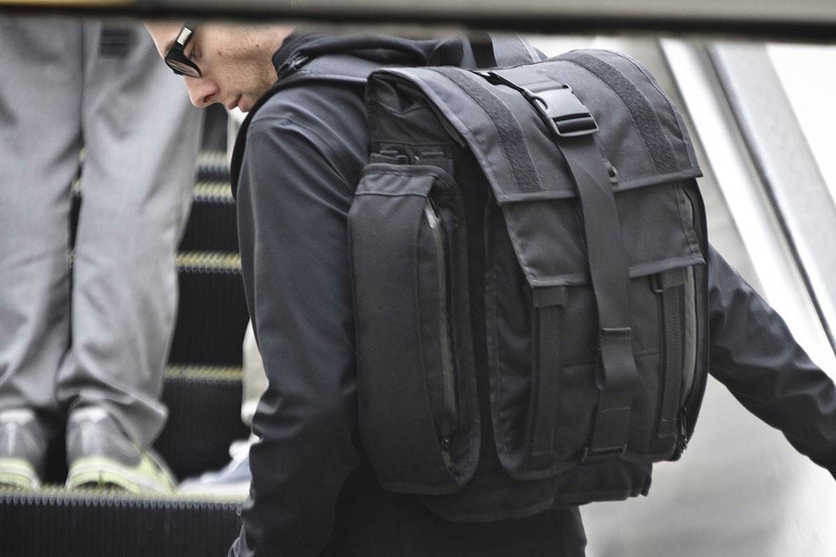 A profile view of a person wearing a Mission Workshop&nbsp;R6 Arkiv Field Pack.