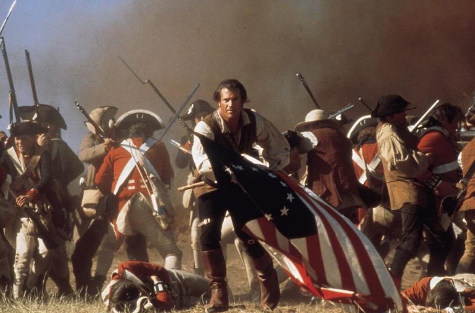 Mel Gibson waves an American flag in the midst of battle in The Patriot.