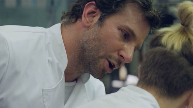 A male chef yells at a female chef.