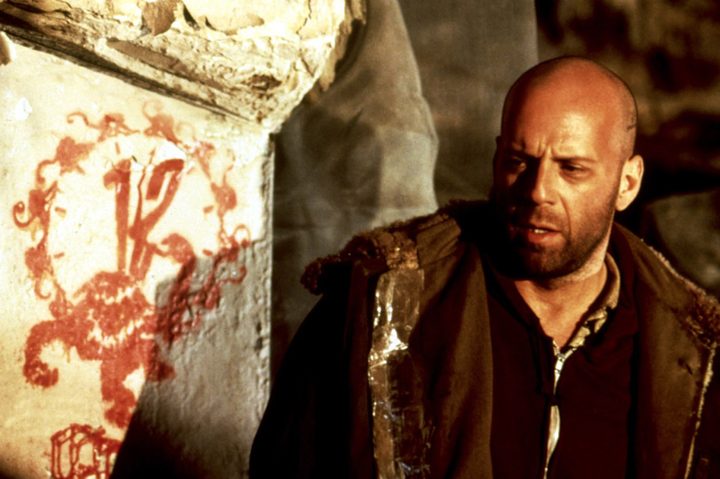 Bruce Willis looking at something off-screen in 12 Monkeys.