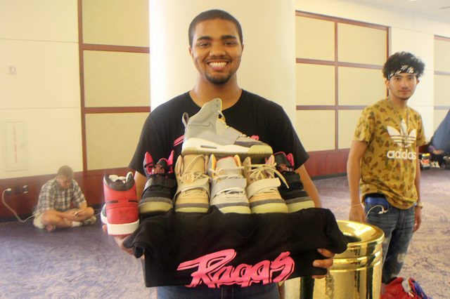 Karon Smith, owner of Raggs Boutique, holding $10,000 worth of sneakers