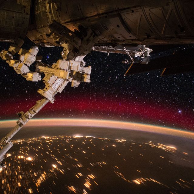 Photo taken by NASA astronaut Scott Kelly of the ISS flying over an aurora