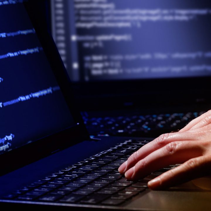 A person inputs code into a system.