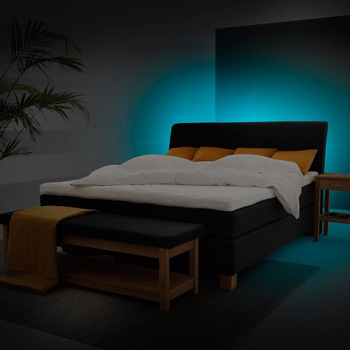 A bed illuminated from behind.