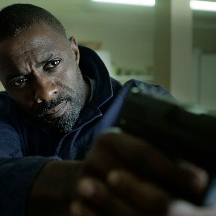 Idris Elba pointing a gun in The Take.
