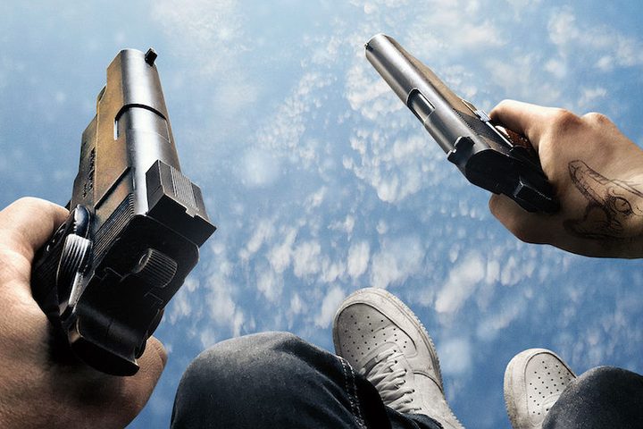 First person POV of a man falling from the sky holding a pistol in each hand in Hardcore Henry.