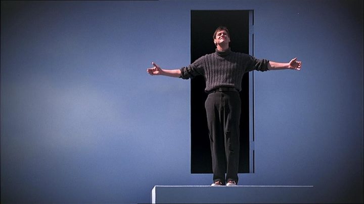 Jim Carrey as Truman Burbank spreading his arms and looking up in "The Truman Show."