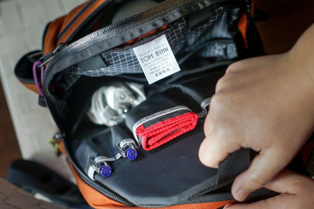 A close up view of a Tom Bihn Synapse 19 backpack opened up to show its inside contents, from a different angle.