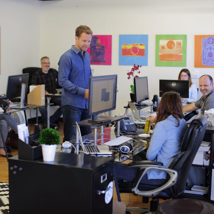 Andrew Funderberg speaks to employees at the Fundy Software office.