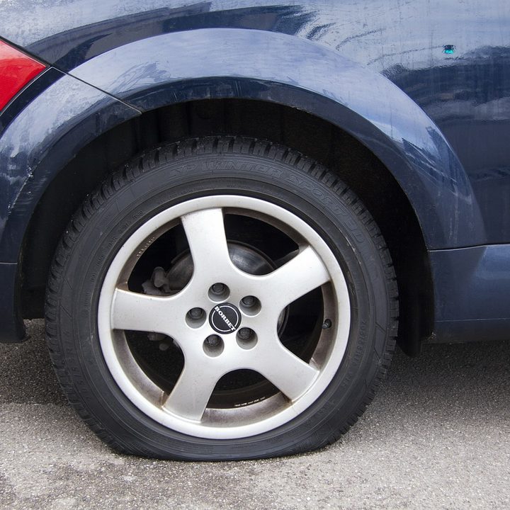 A flat tire on a car.
