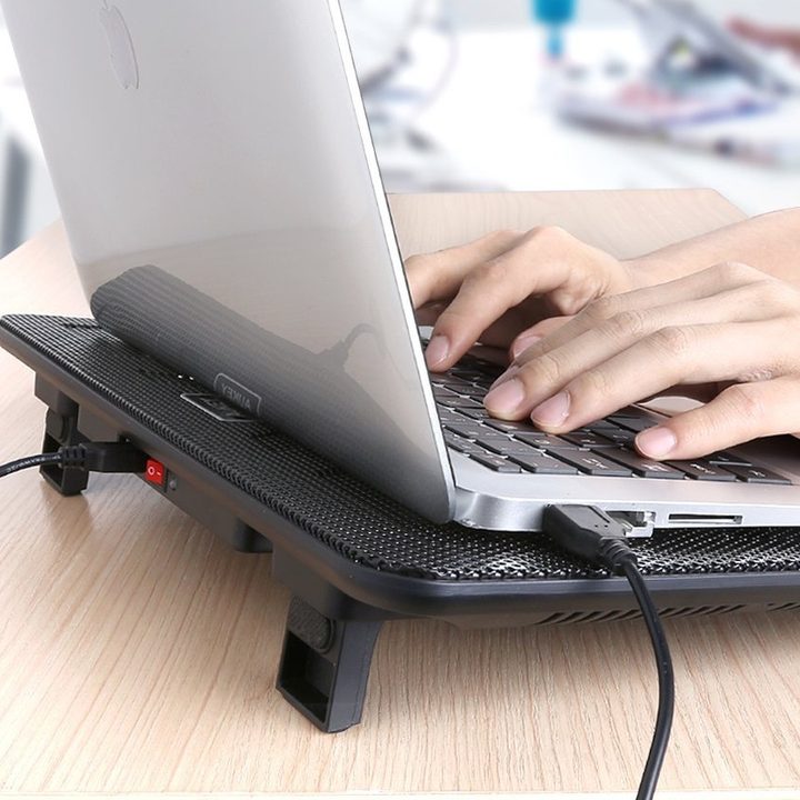 A laptop with a cooling pad.