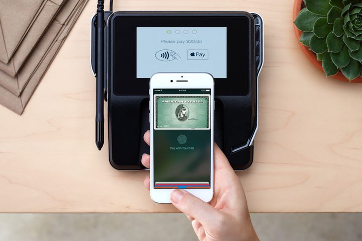 Someone using Apple Pay with their iPhone.
