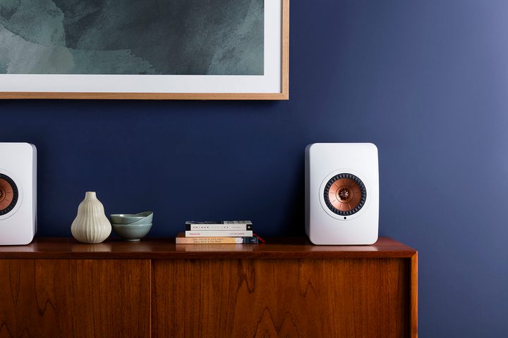 The KEF LS50 Wireless II placed on a surface in a living room.