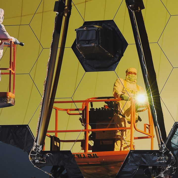 A scientist examines the mirrors on the James Webb Space Telescope.