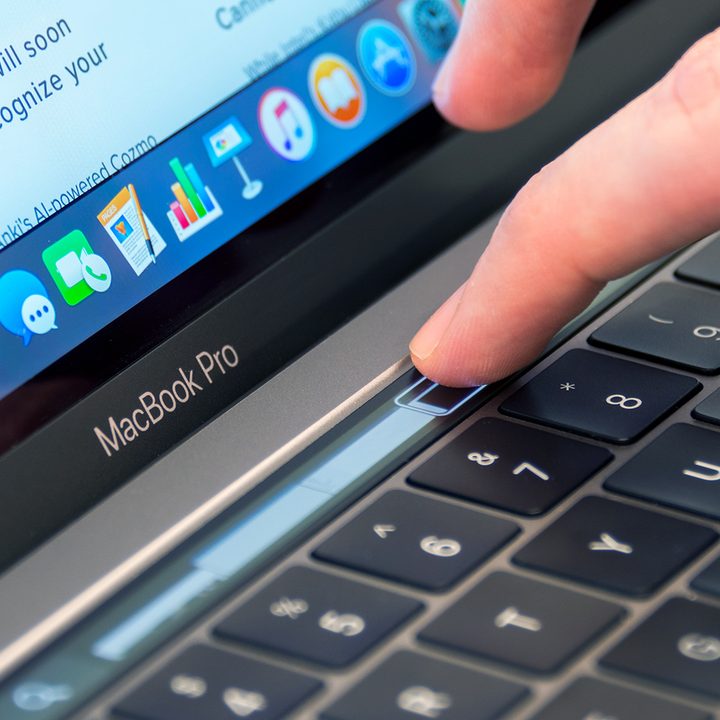 A user adjusting a slider on the MacBook Pro TouchBar.