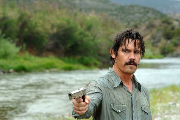 A man points a gun in No Country for Old Men.