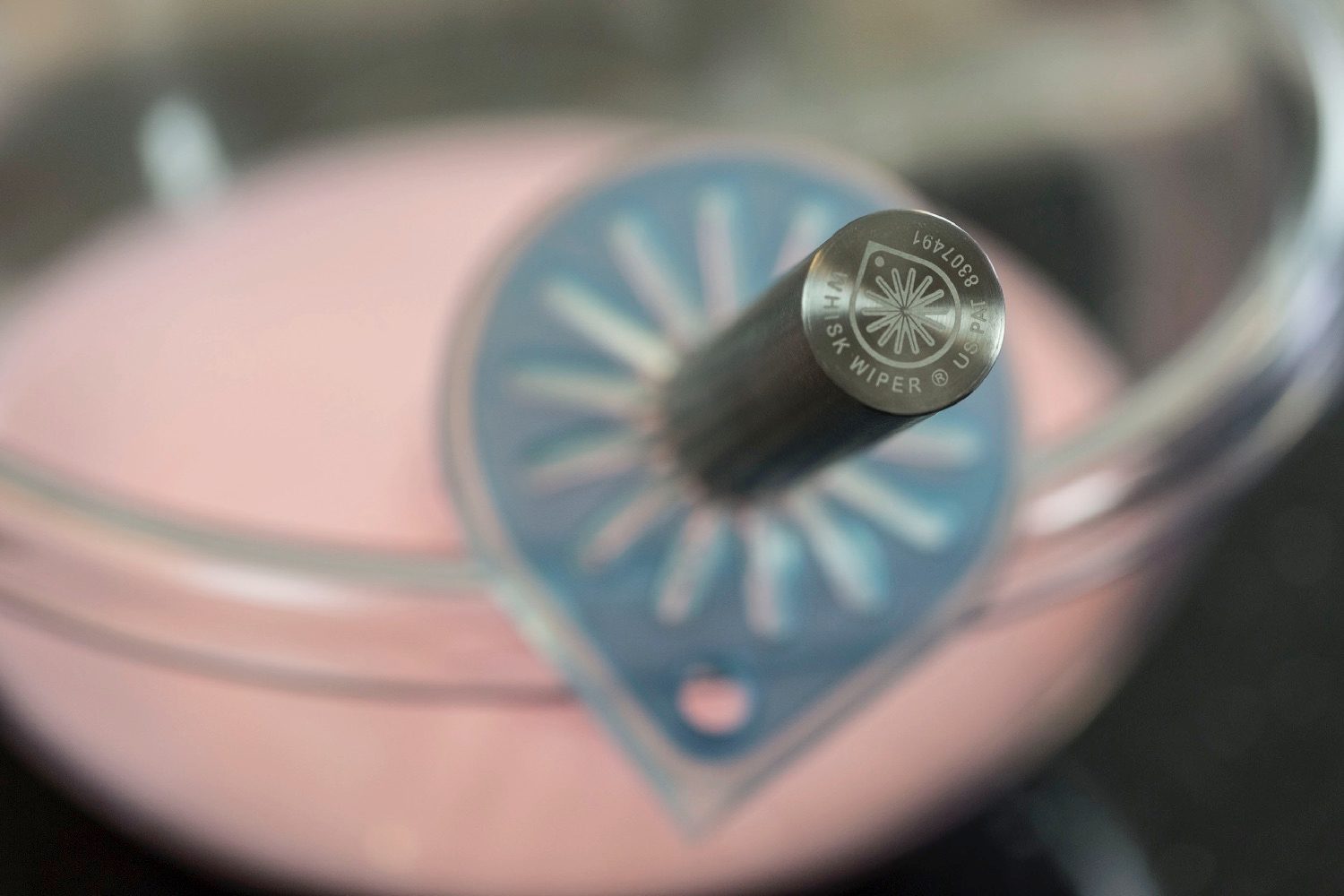 whisk wiper kickstarter mounted on bowl bottom closeup