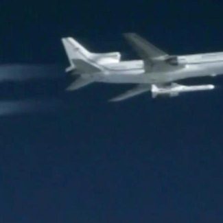 A Pegasus rocket carrying eight small satellites launches from a plane 100 miles east of Daytona Beach, Florida.