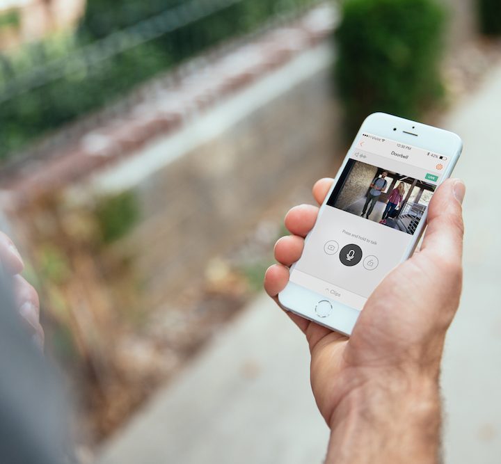 Person reviewing Vivint security settings on smartphone.