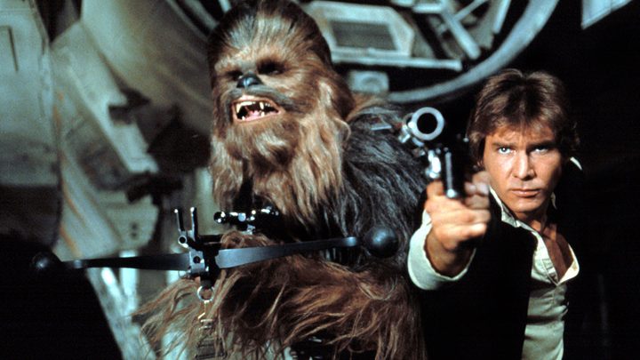 Chewbacca and Han Solo aiming guns.