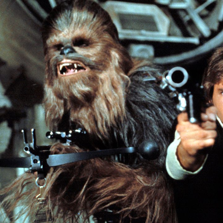 Chewbacca and Han Solo aiming guns.