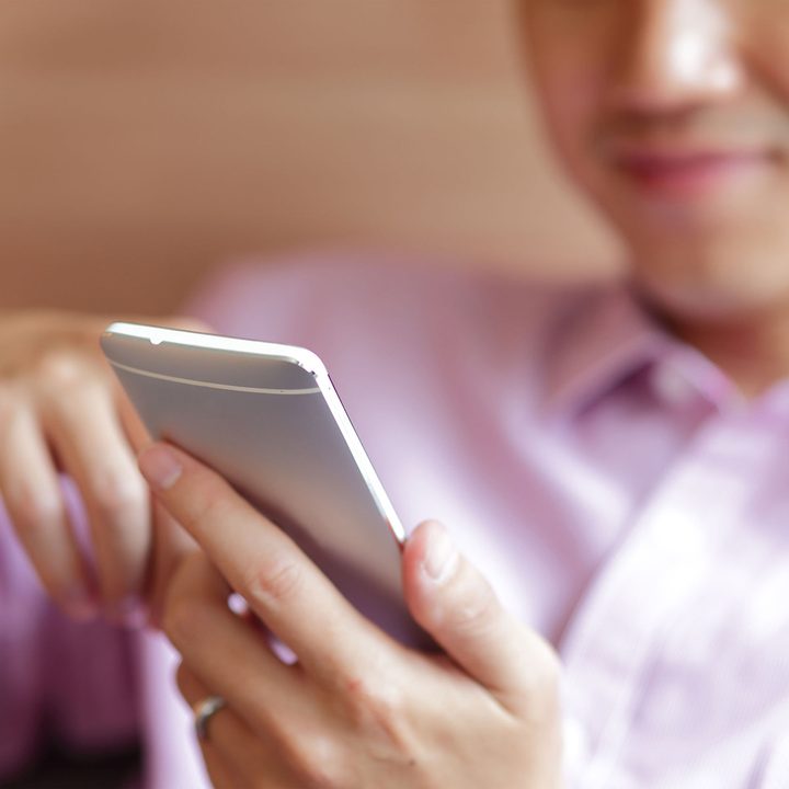A man looks on his phone.