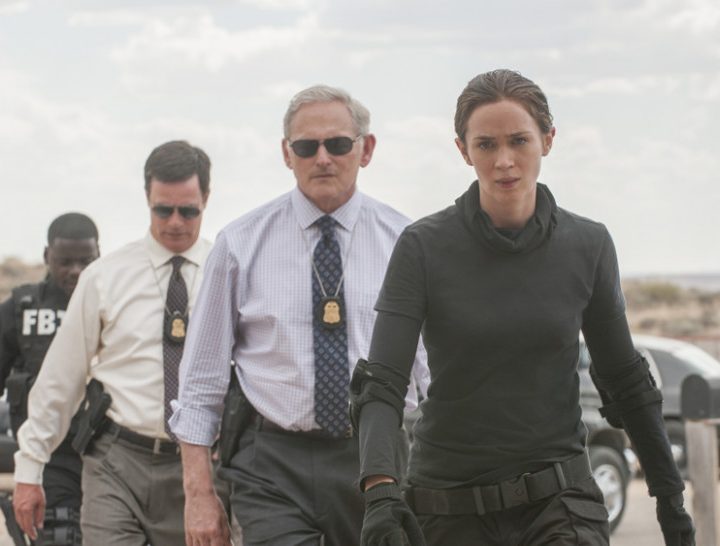 Emily Blunt and multiple agents walk toward the camera in Sicario.